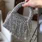 Handmade-clutch-featuring-acrylic-and-tassel-elements