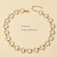 sophisticated-gold-necklace-with-pearl-flower-embellishments